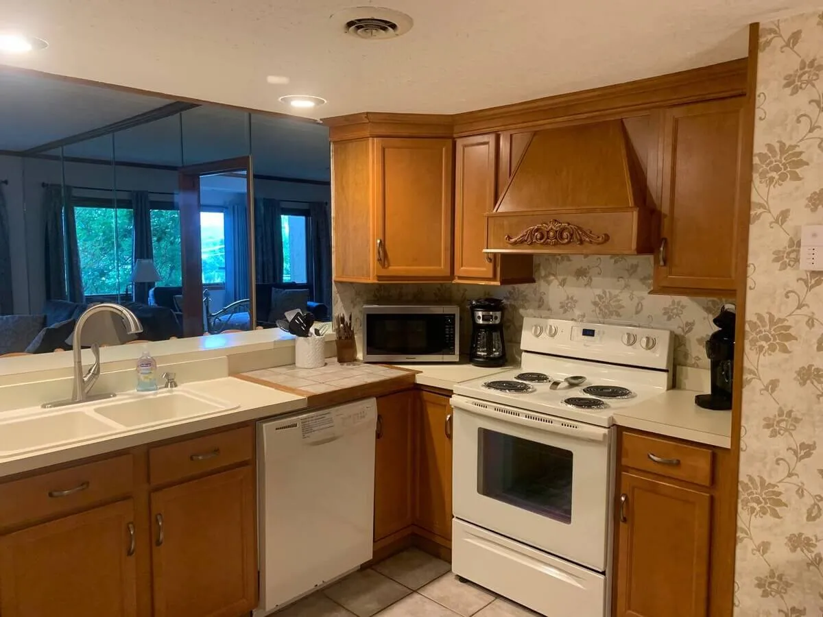 Warm and welcoming kitchen with ample countertop space, modern appliances, and wooden cabinets. The cozy ambiance suggests a space ideal for both meal preparation and family gatherings, with enough room for multiple cooks or helpers.